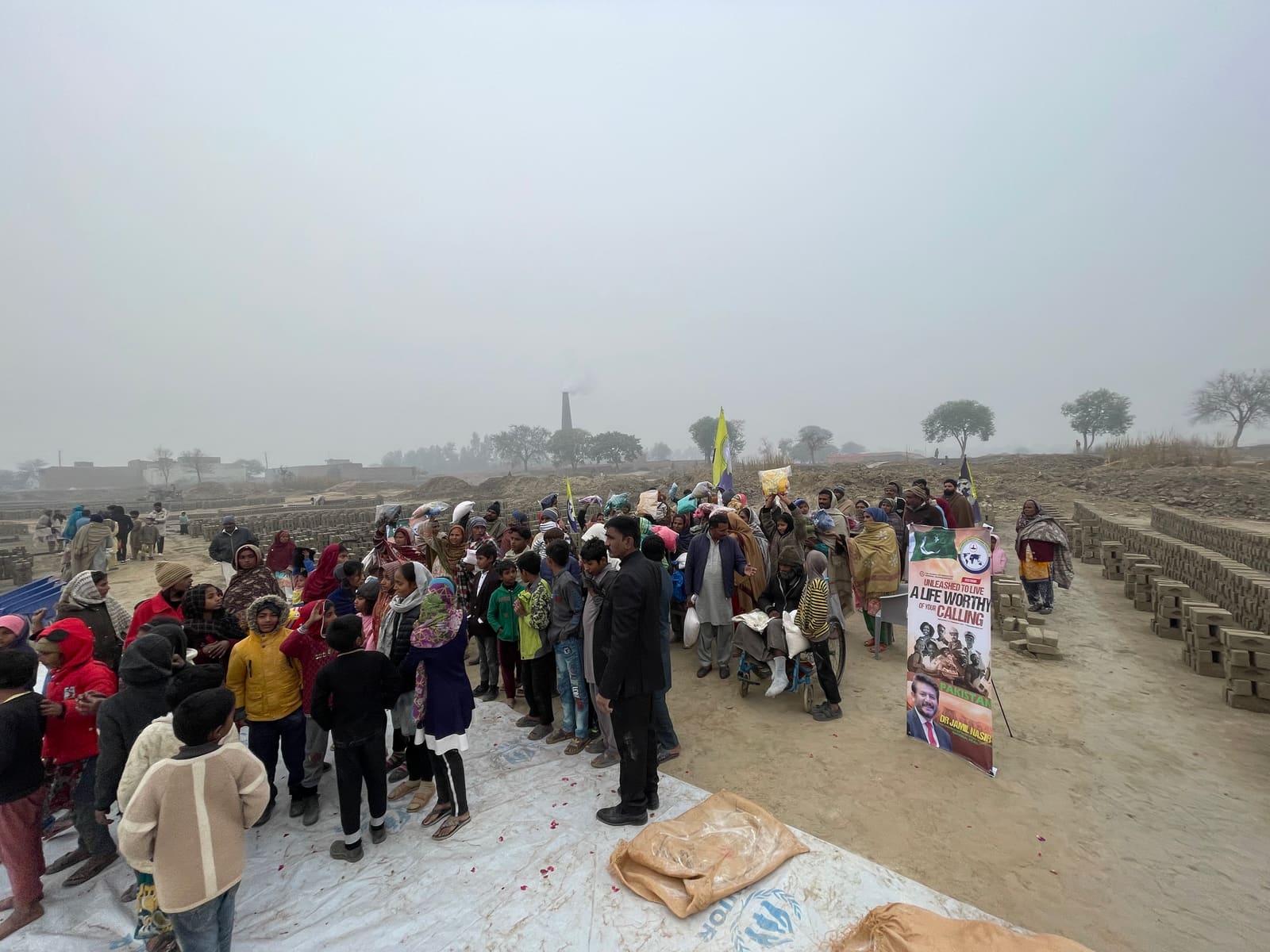 COPPAK gathering with families at a brick kiln
