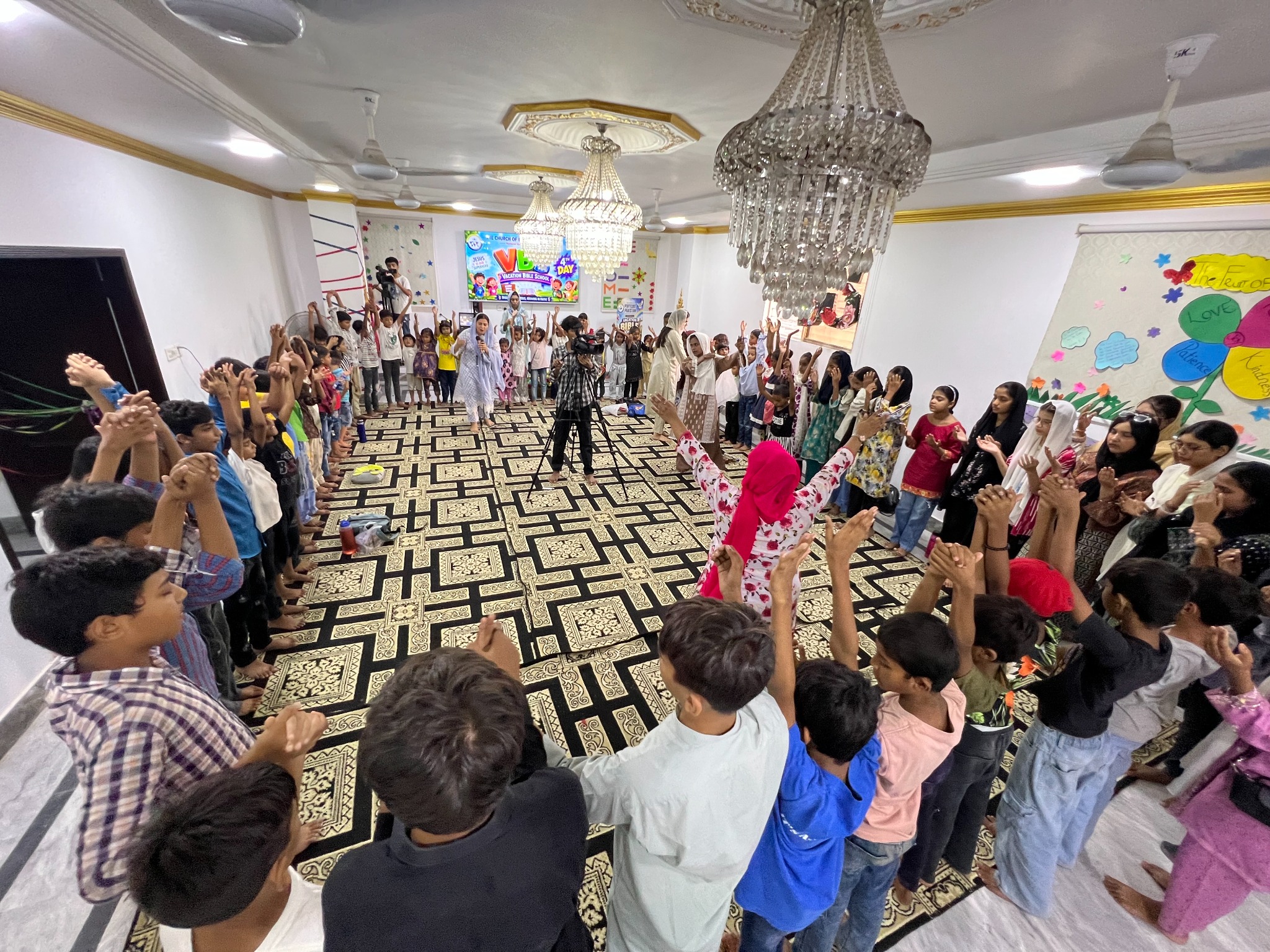 Children and facilitators gather for a joyful VBS activity.