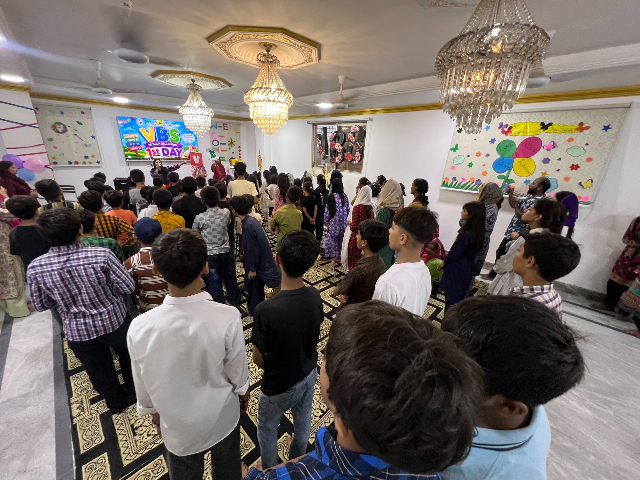 Children gathered for collective worship and teaching.