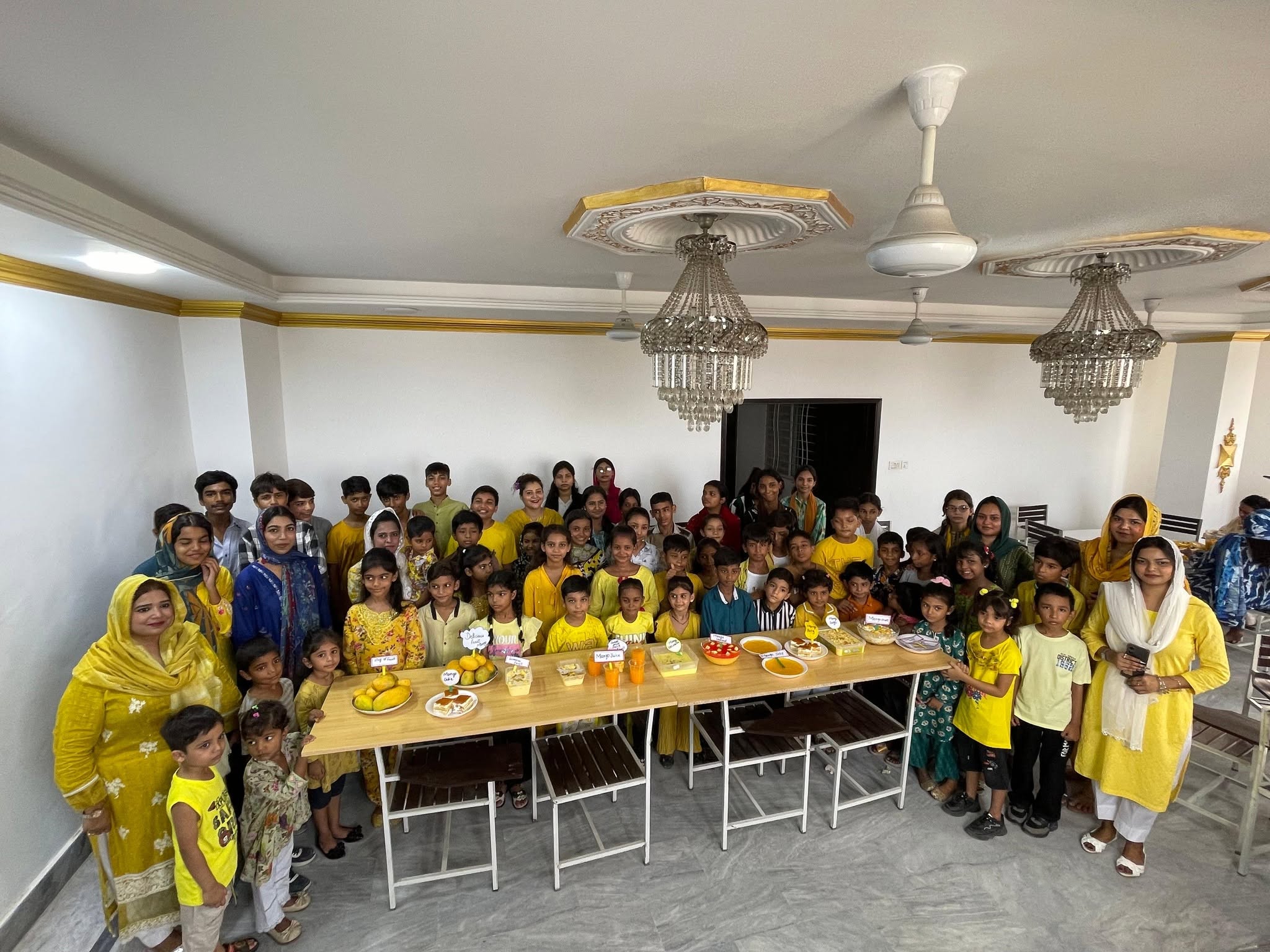 Children and adults sharing a joyful group activity.