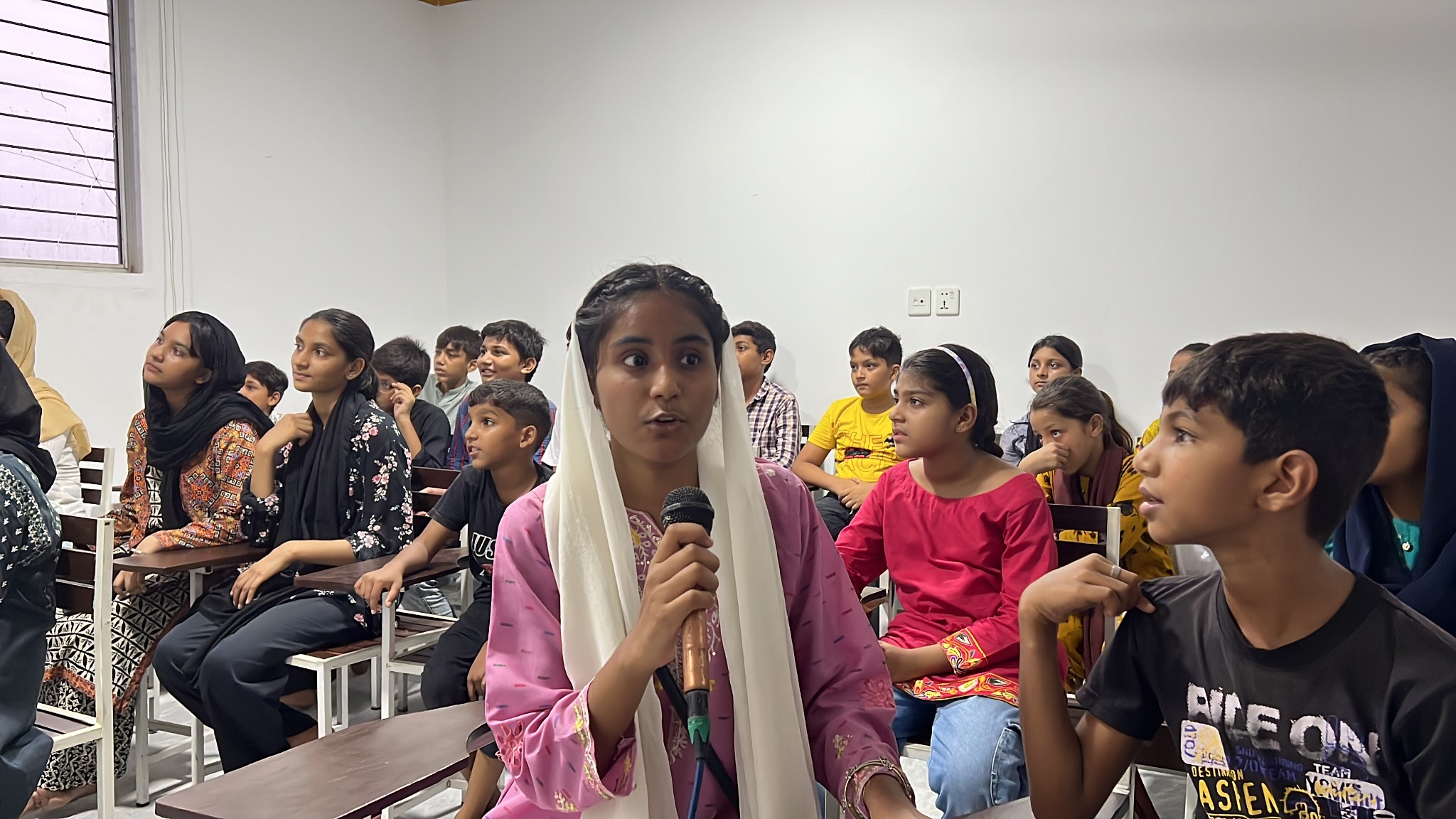 A young participant contributes during a discussion.