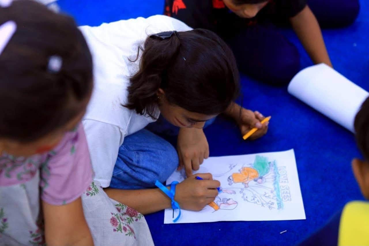 Children carefully work on illustrated activity sheets.