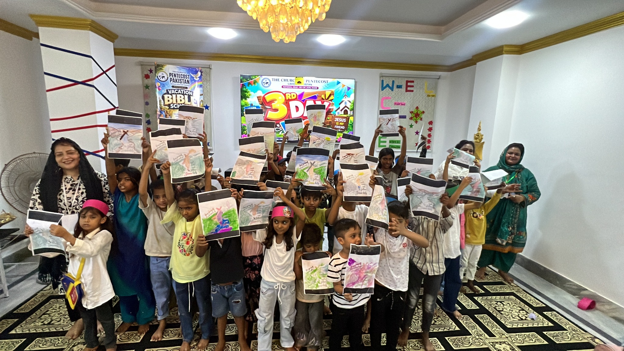 Participants proudly display their completed artwork.