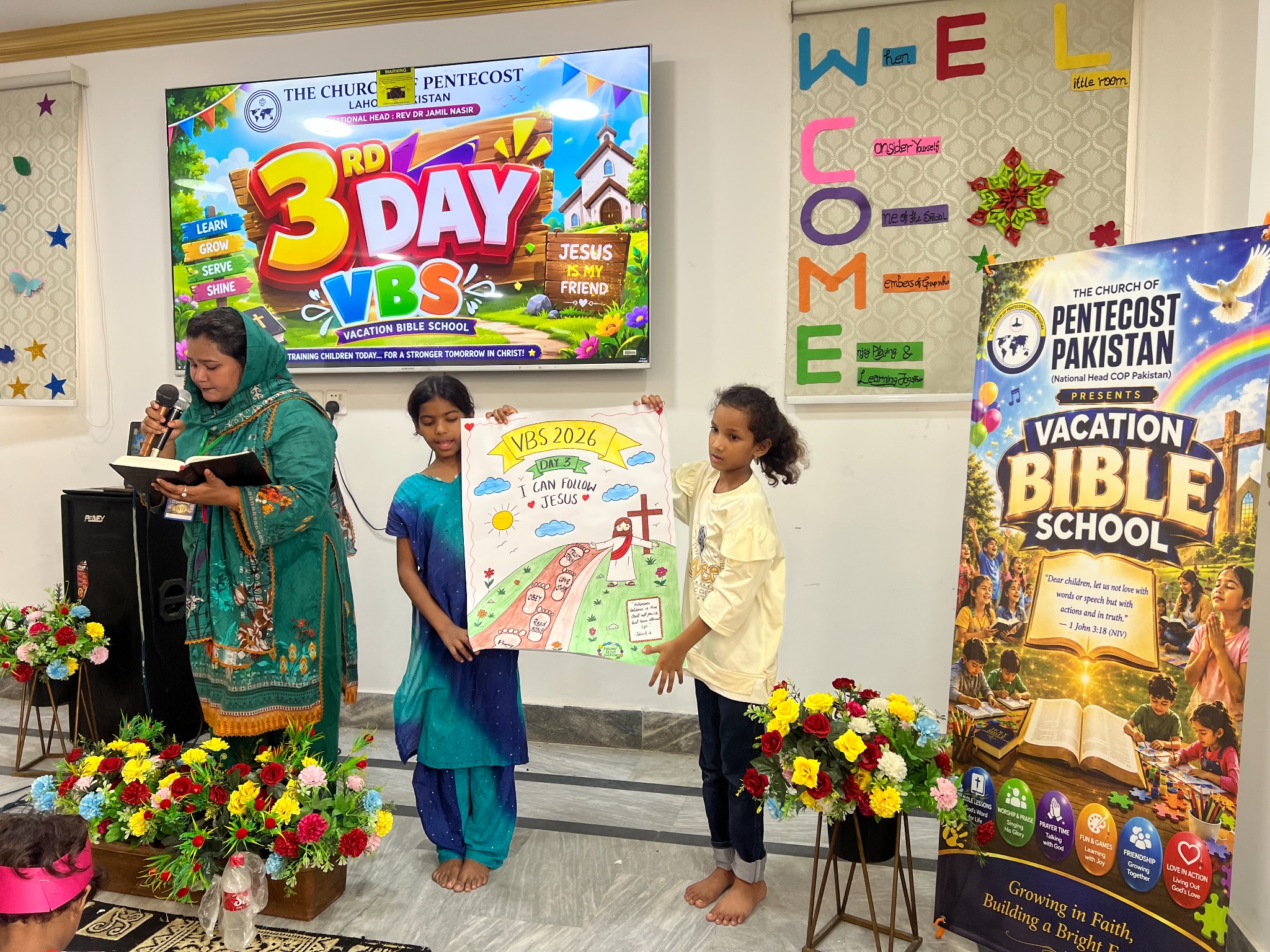 Children share the day’s lesson through a poster presentation.