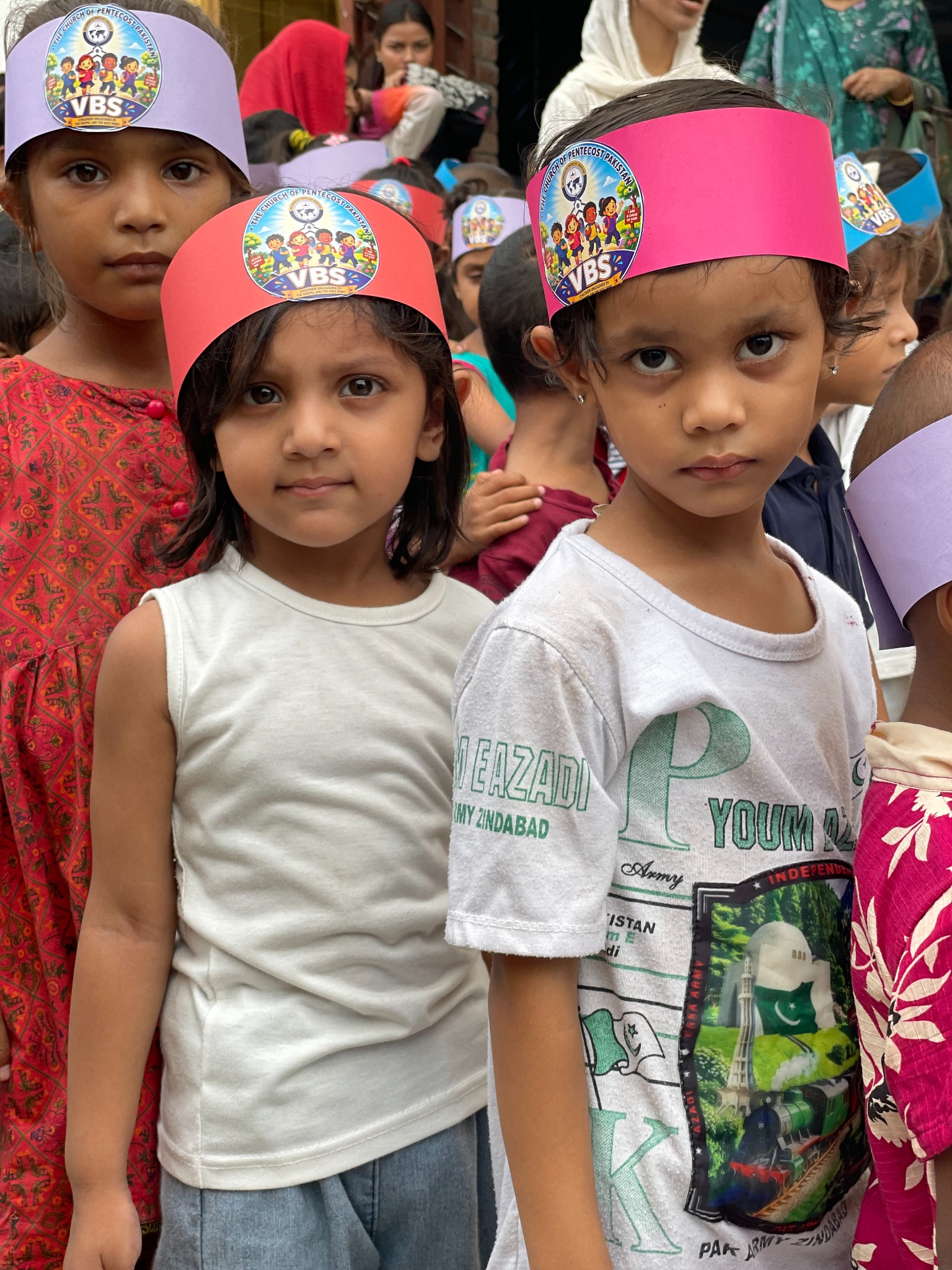 Young participants share a moment of fellowship in their VBS headbands.
