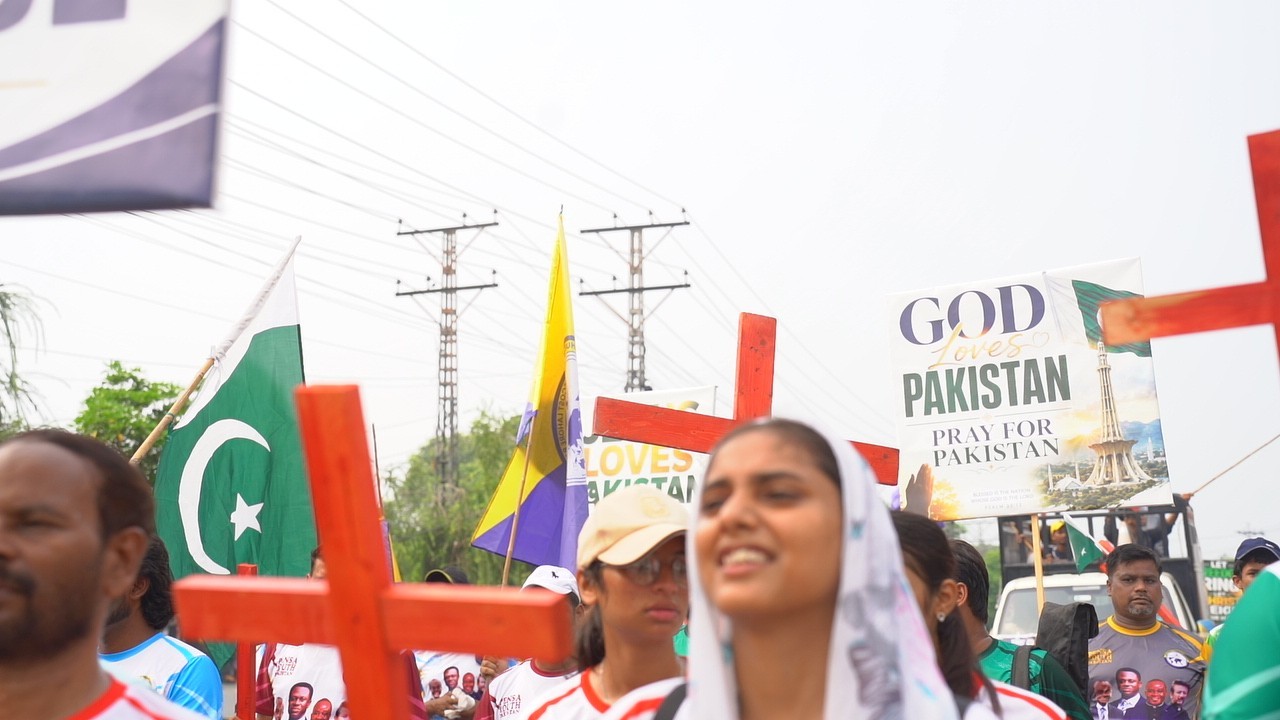 A young participant carries a cross during the rally.