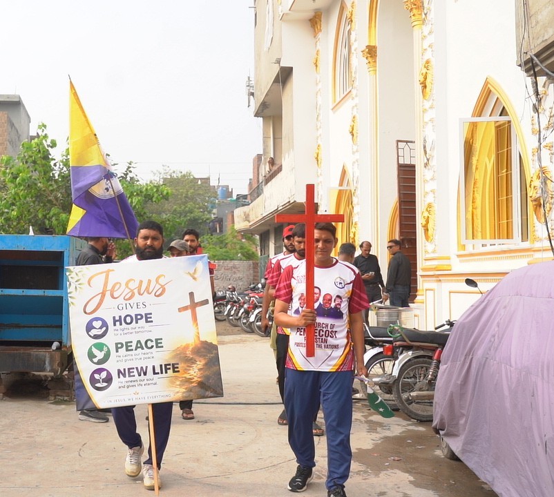 The Gospel procession moves past a church in Lahore.